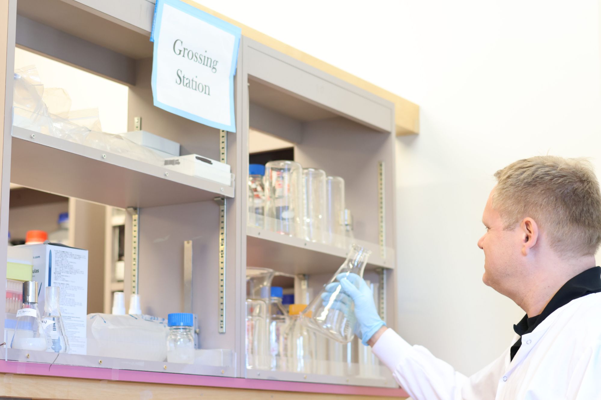 Histotechnologist retrieving clean glassware