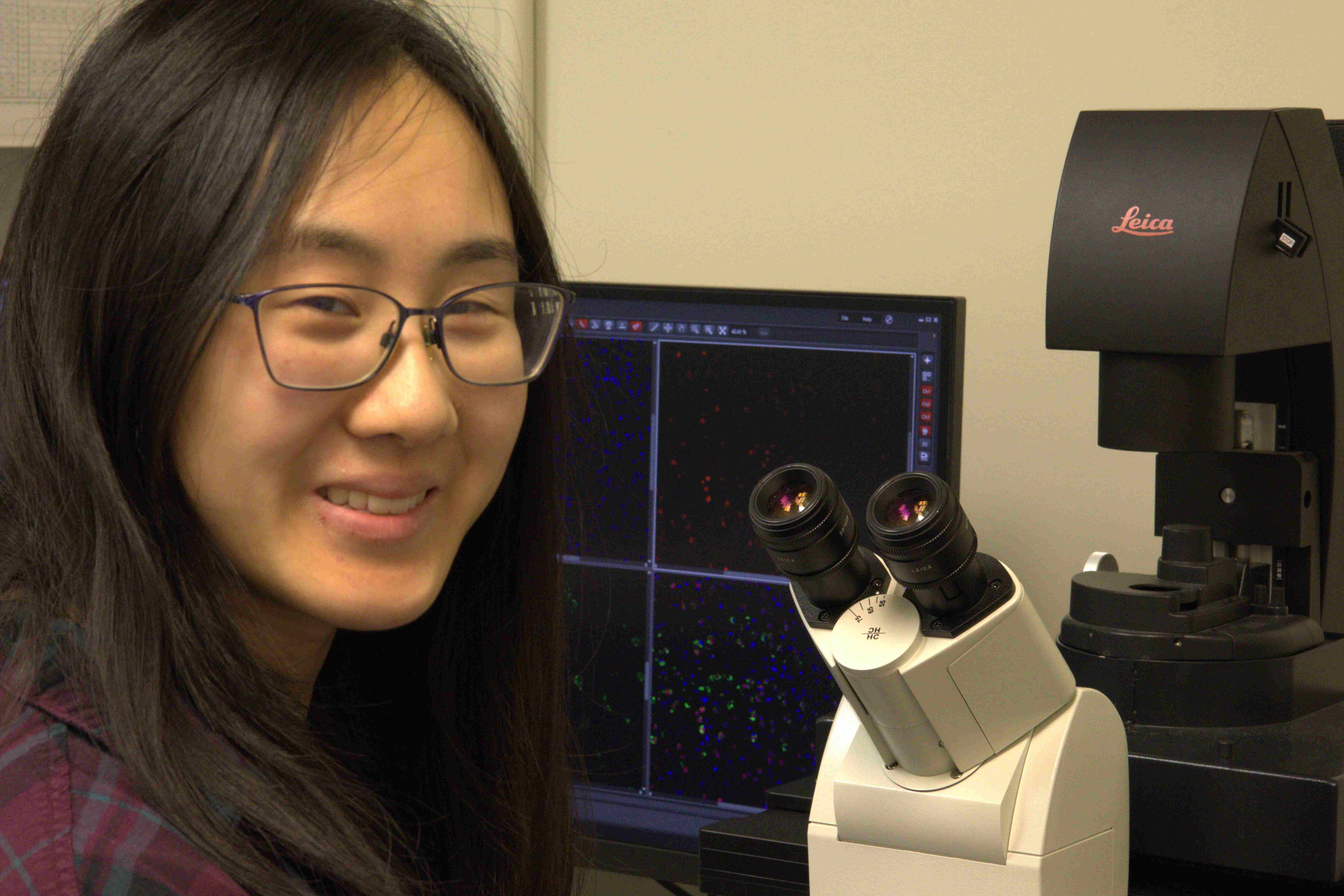 Histotechnologist operating Leica Thunder microscope