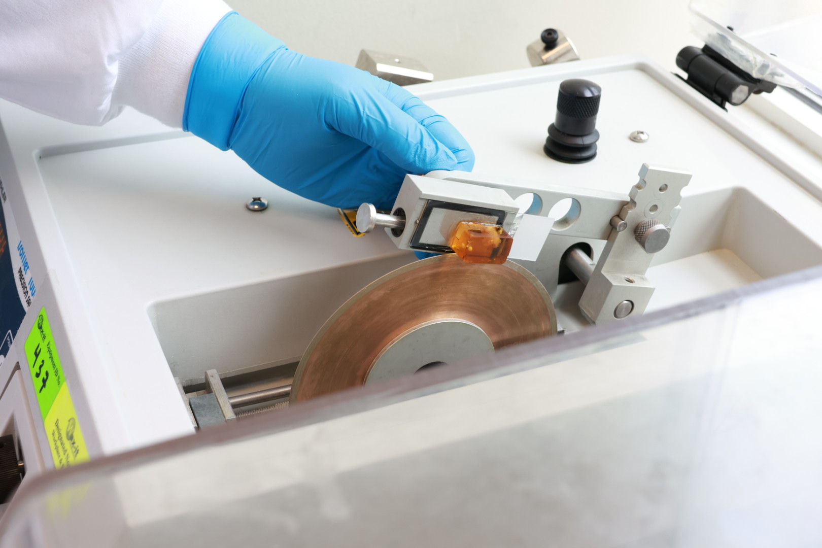 Resin histotechnologist cutting resin blocks