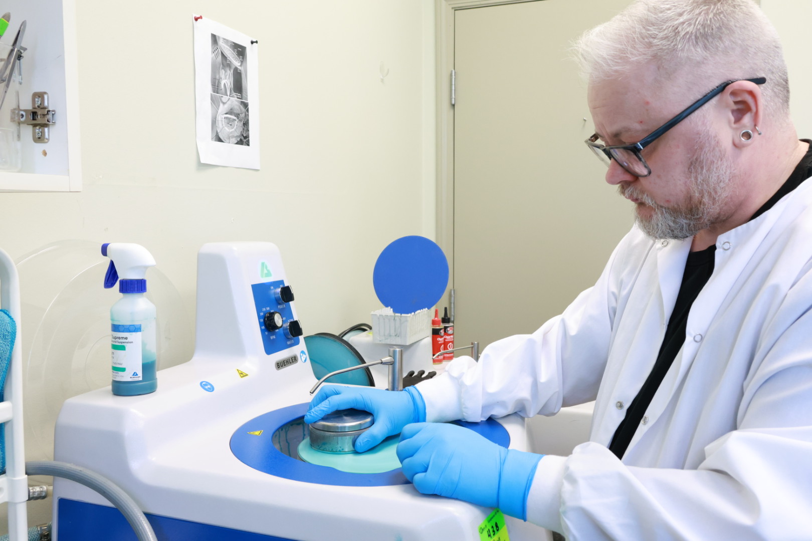 Resin histotechnologist grinding and polishing resin sections